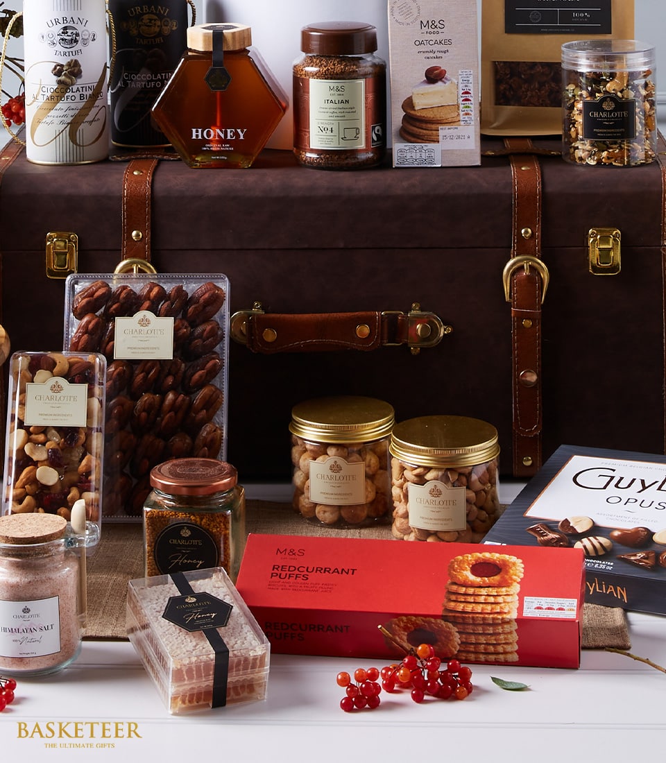 Premium Moët Champagne luxury gift hamper with gourmet chocolates, nuts, honey, and artisan treats in leather trunk