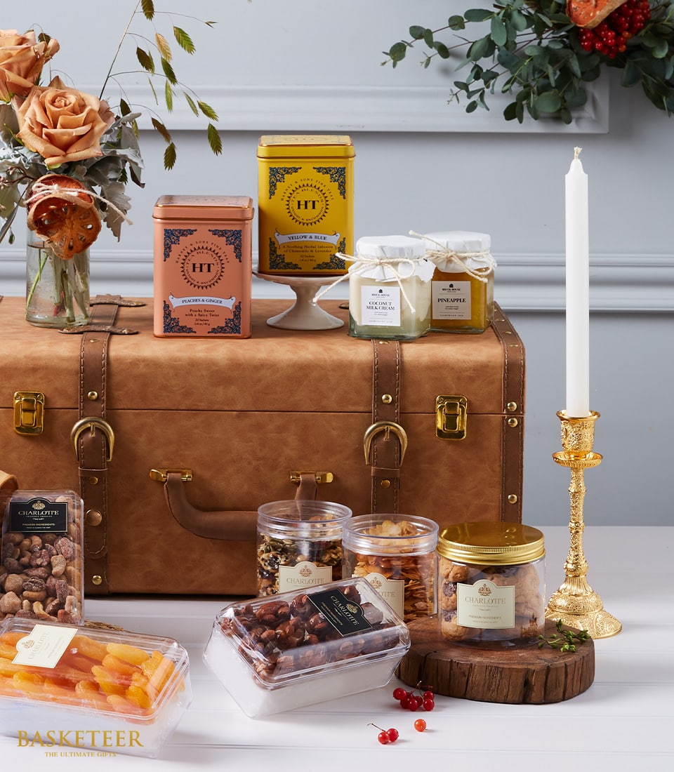Luxury gift hamper with gourmet tins, artisan jars, dried fruits, nuts, Charlotte cookies, peach roses and candle