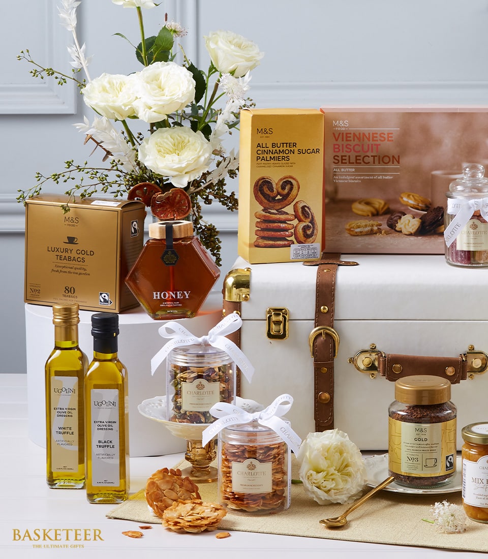 Luxury Worldly Treats hamper with white trunk, gourmet selection, white roses, and gold accents