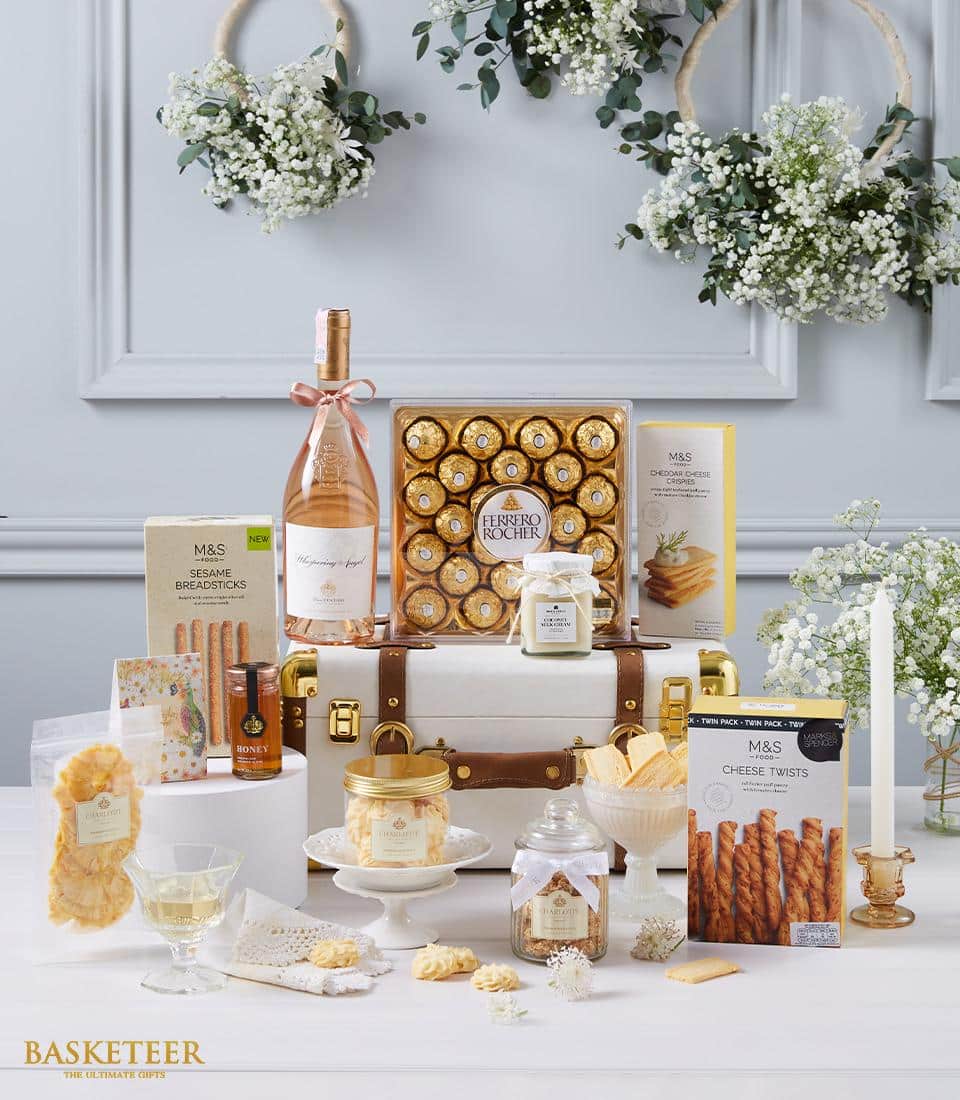 Premium wine and gourmet hamper with rosé, Ferrero Rocher, and artisan treats in leather-trimmed trunk