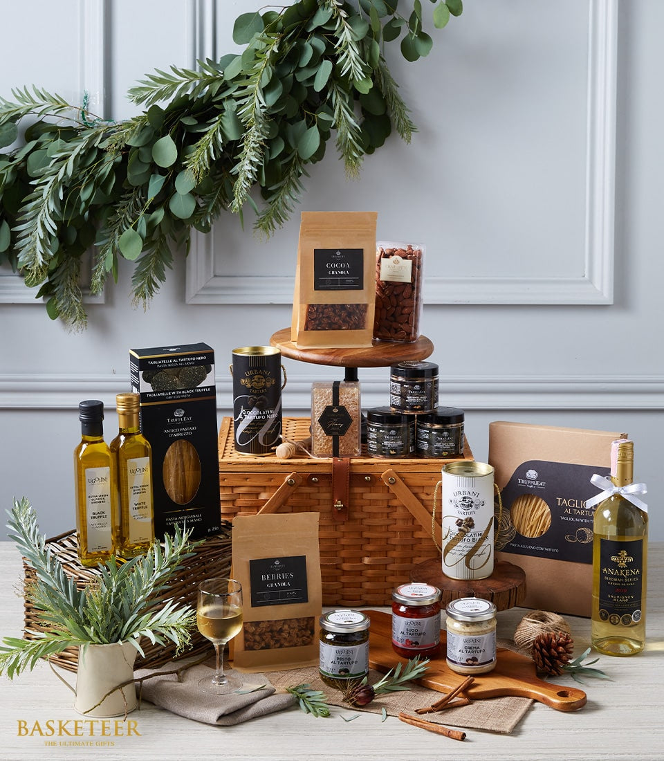 Premium gourmet hamper with white wine, truffle pasta, olive oil, and artisan spreads in wicker basket