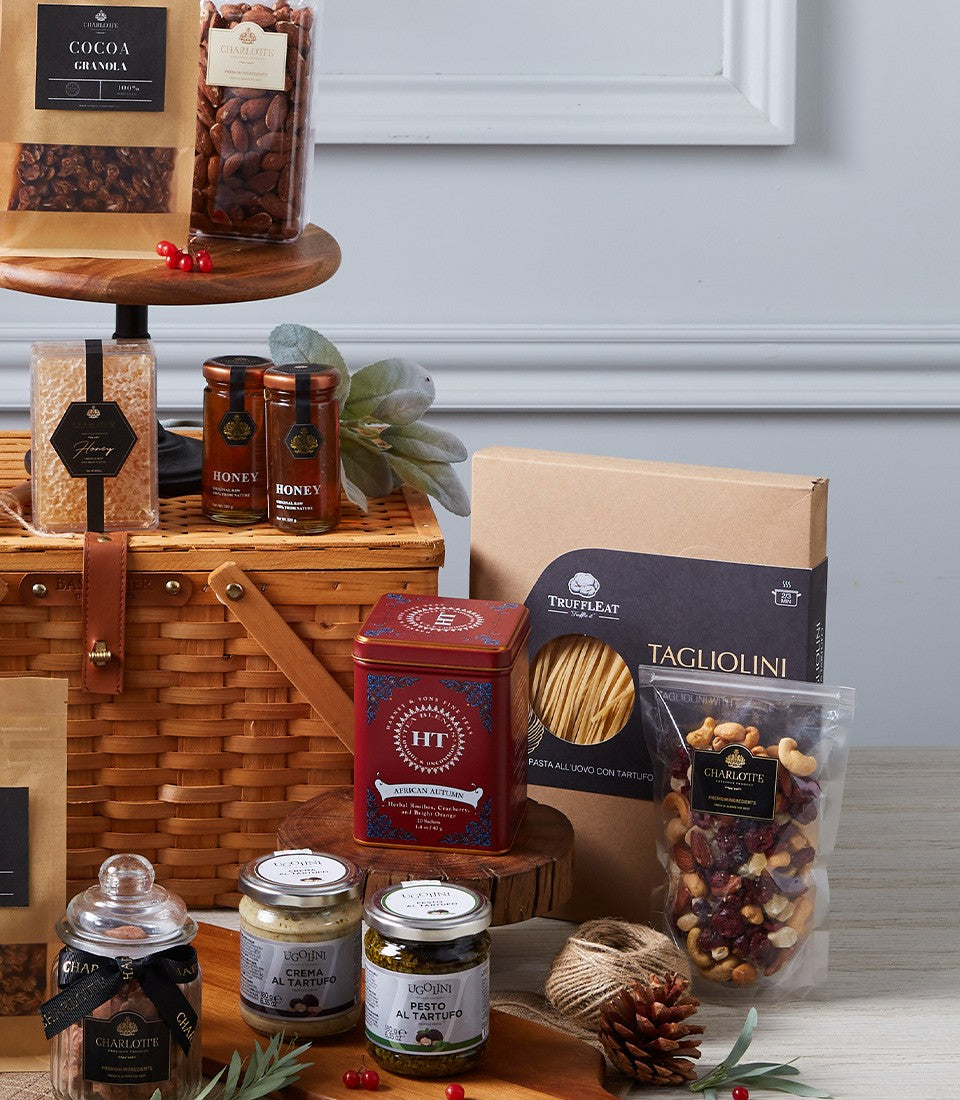 Luxury gourmet hamper with truffle spreads, honey, artisan tea, and premium nuts in woven wicker basket
