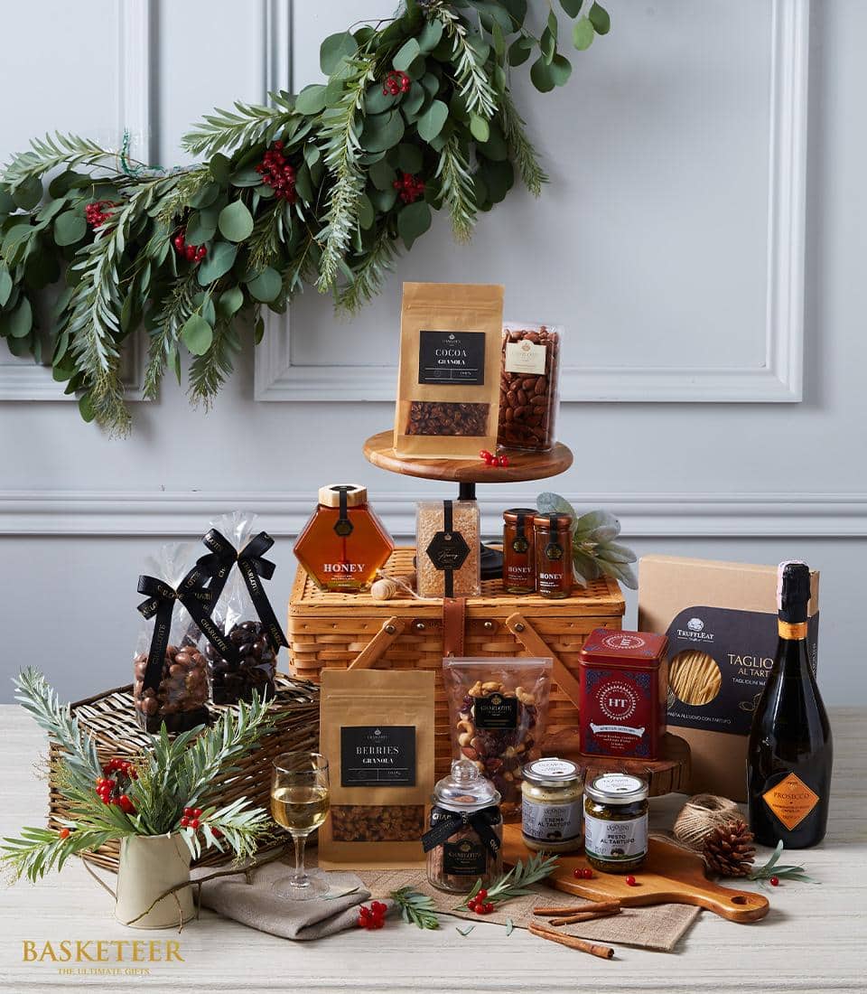 Premium wine and gourmet delicacies gift basket with sparkling wine, nuts, honey, and artisan treats