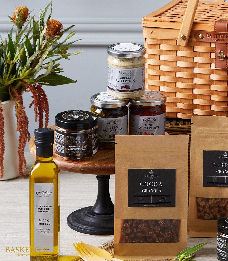 Luxury imported truffle delicacies hamper with artisan granola, olive oil, and gourmet spreads in wicker basket