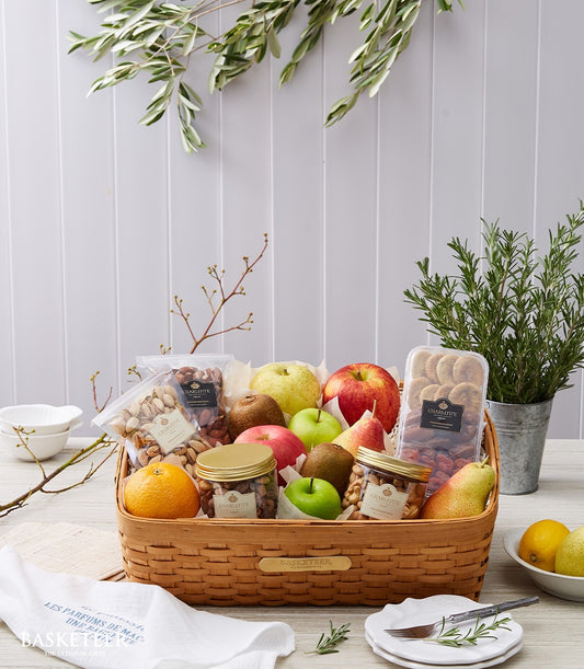 Woven fruit and nuts gift basket with fresh apples, kiwis, pears, and healthy snacks for get well recovery