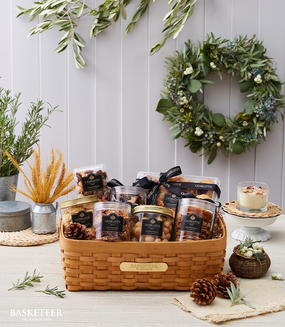 Luxury organic gift basket with gourmet nuts, dried fruits, granola, fresh rosemary, and artisan treats