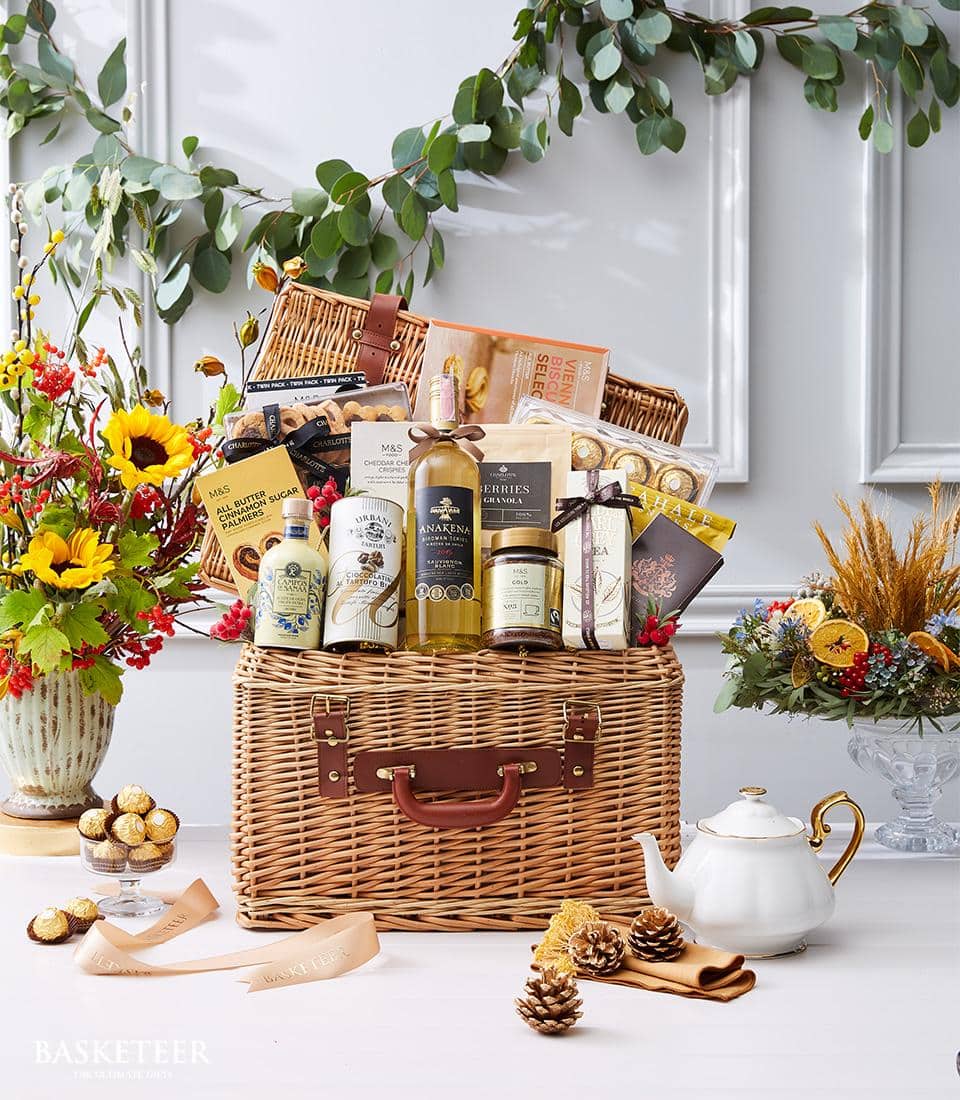 Luxury wicker hamper with white wine, gourmet chocolates, honey, and premium treats