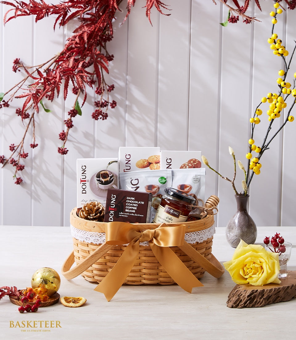 Doi Tung Delights wicker gift basket with coffee, honey, and artisan treats tied with gold satin ribbon