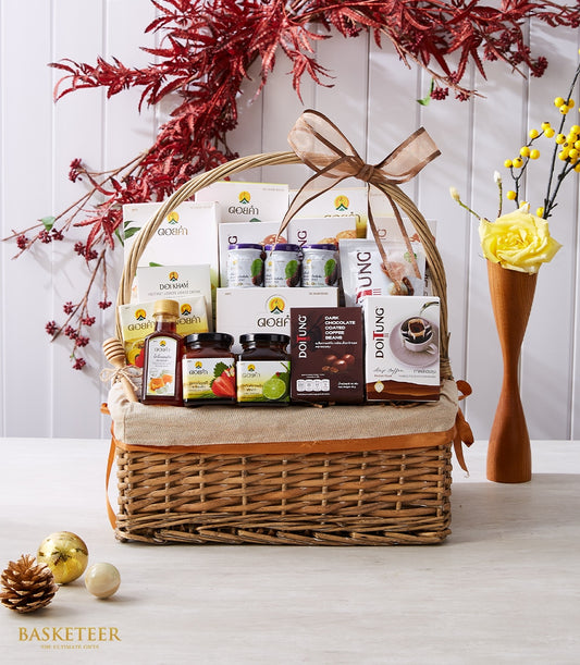 Woven wicker gift basket filled with Doi Tung and Doi Kham gourmet treats, honey, preserves, and specialty coffees with