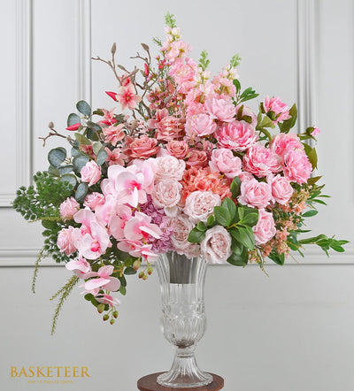Elegant pink peony and orchid arrangement in clear glass vase with eucalyptus, perfect for congratulations or celebration