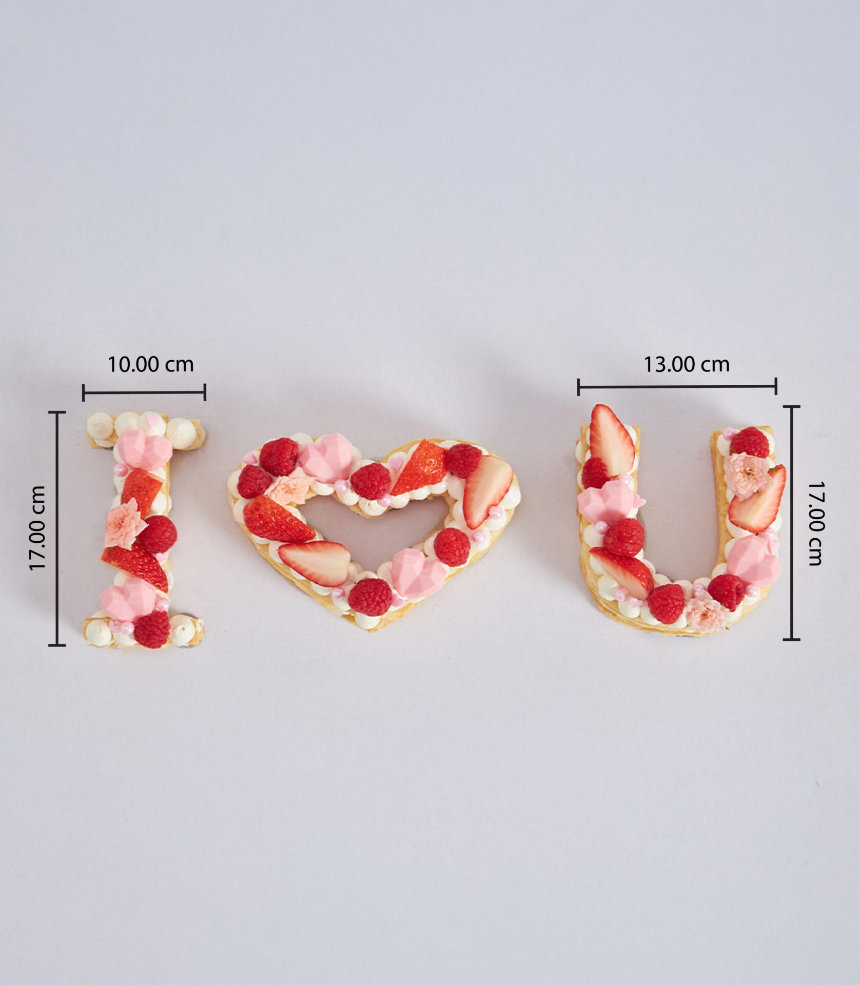 I Love You letter cake set with fresh raspberries and strawberries, artisan cream tarts for birthdays and celebrations