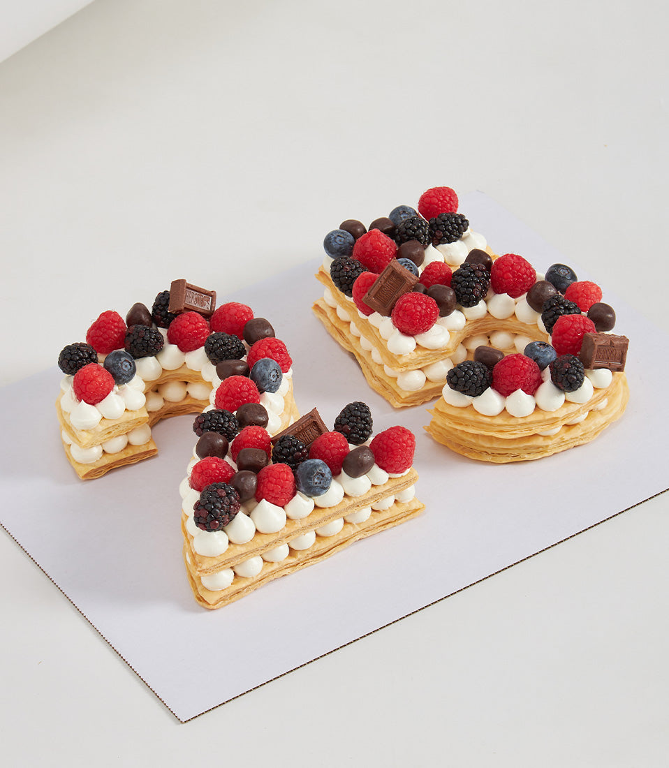 Number 21 personalised chocolate and berry layer cake with fresh raspberries, blackberries, blueberries, and cream rosettes