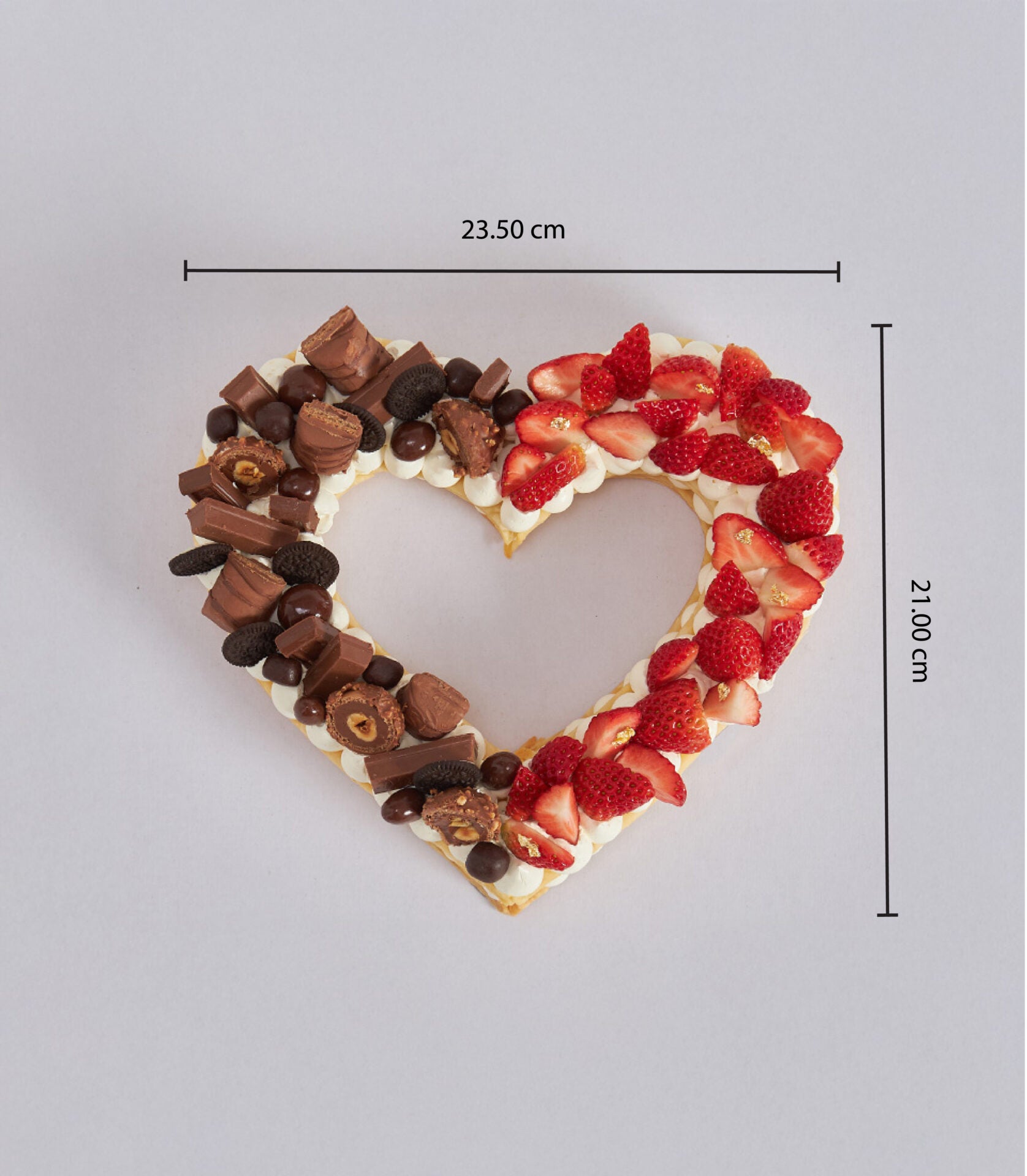Heart-shaped chocolate and strawberry pie cake with gold leaf berries and chocolate candy, perfect for birthdays