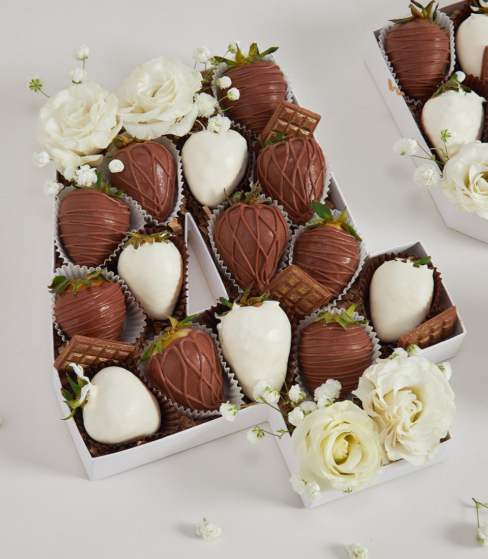 Classy chocolate strawberry letter box with milk and white chocolate-dipped berries, chocolate waffles, and white roses