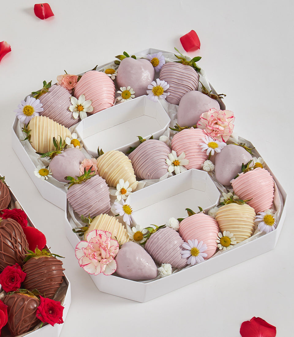 Number 8 chocolate-covered strawberry birthday gift box with pastel pink, lavender and yellow coatings, fresh daisies and