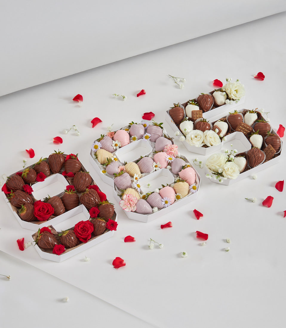 Letter-shaped chocolate-covered strawberry boxes with roses for birthday celebrations