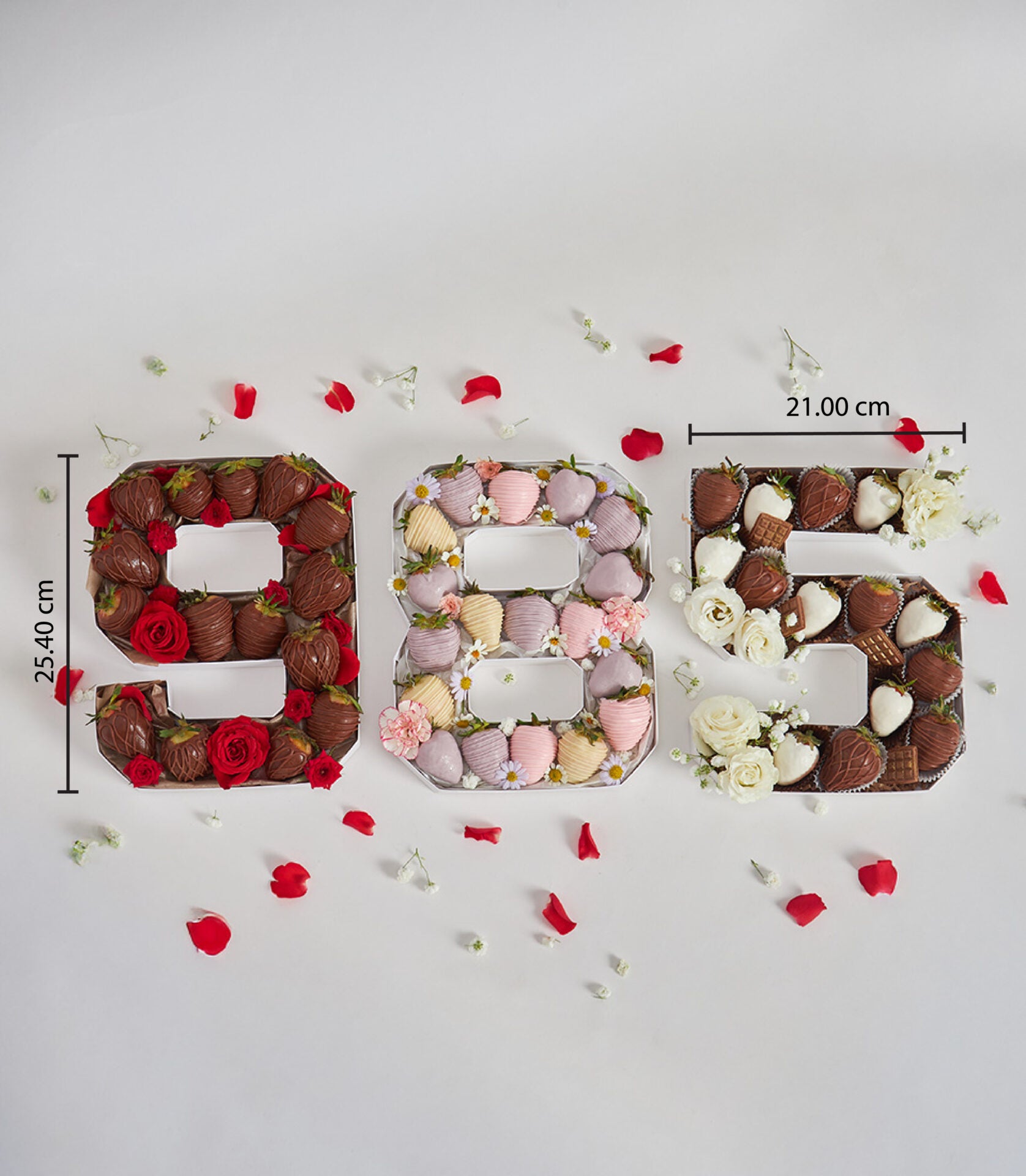 Number-shaped birthday boxes filled with chocolate-covered strawberries and fresh flowers