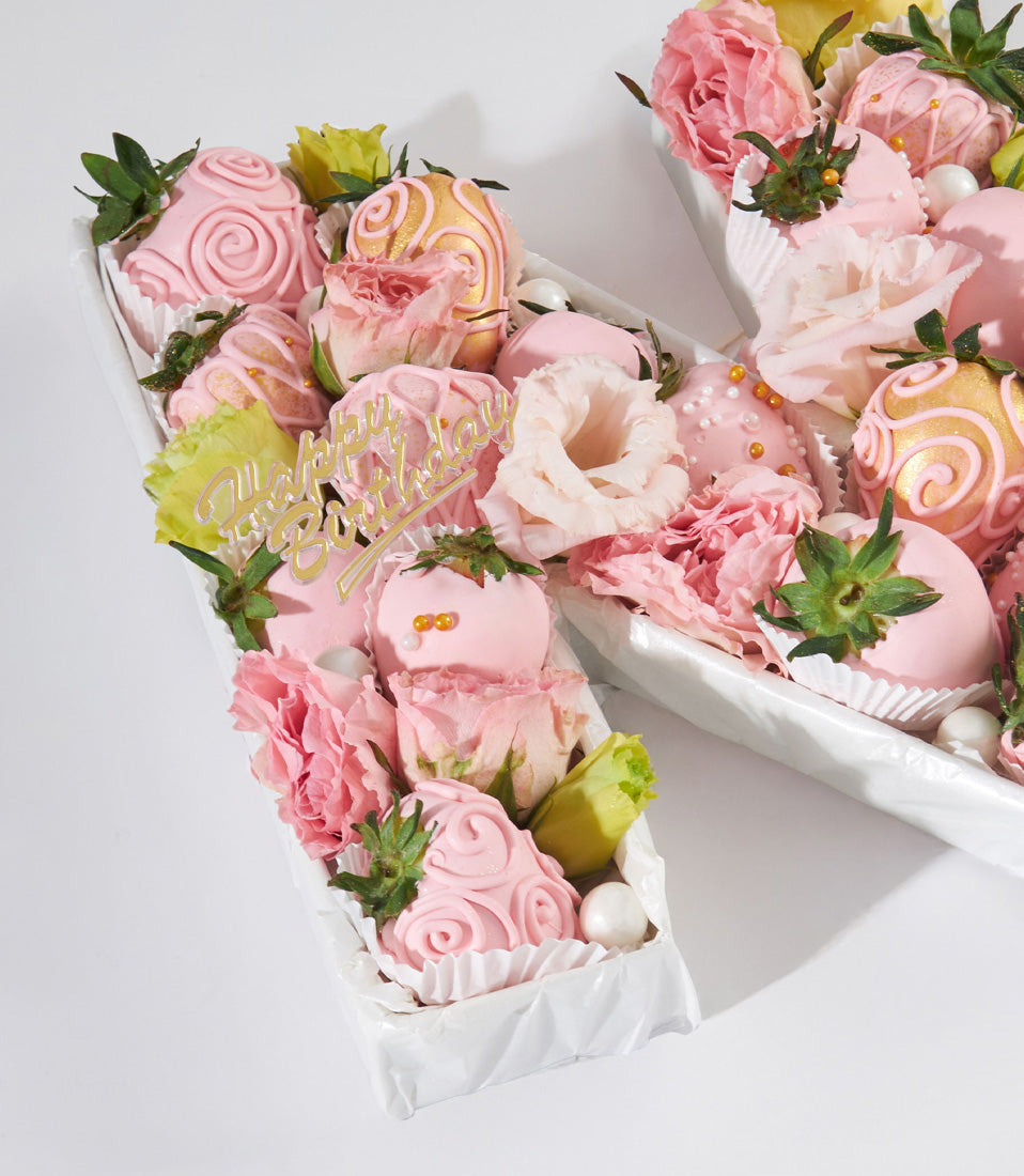 Luxury strawberry and flower letter box with chocolate-covered berries, pink roses, and gold Happy Birthday topper
