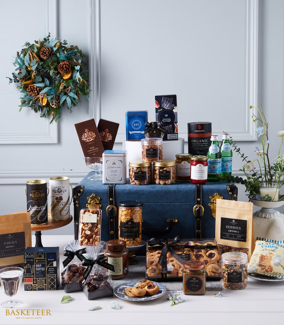 Luxury imported gourmet hamper with dark blue velvet trunk, featuring premium chocolates, coffee, nuts, preserves and