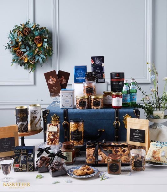Luxury imported gourmet hamper with dark blue velvet trunk, featuring premium chocolates, coffee, nuts, preserves and