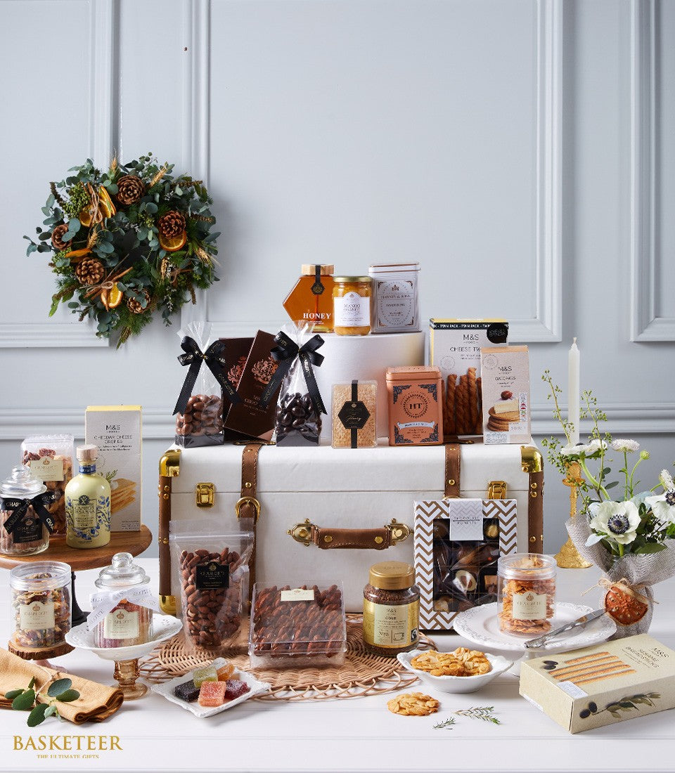 Luxury World Delicacies hamper with gourmet chocolates, nuts, jams, and crackers in elegant trunk-style box with leather