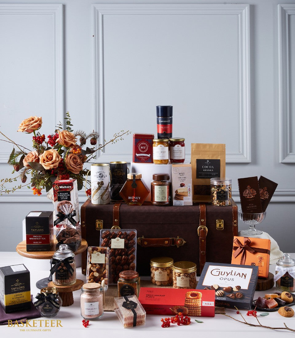 Luxury gift hamper with leather trunk, gourmet chocolates, teas, honey, and peach roses for premium gifting