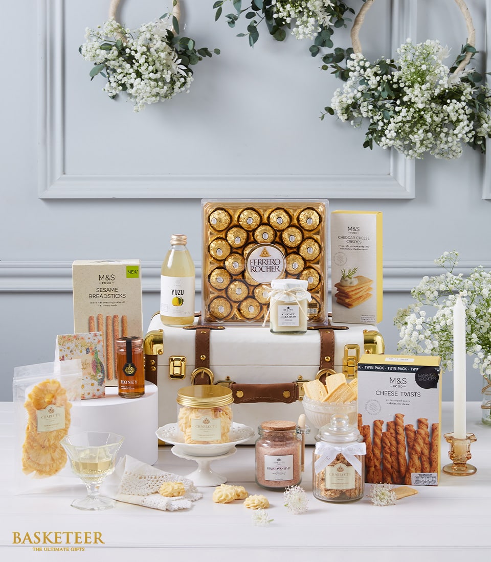 Deluxe white vintage trunk hamper with Ferrero Rocher chocolates, gourmet snacks, and artisan treats on elegant display
