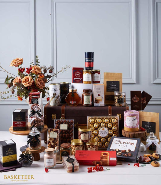 Luxury International Elegance hamper with peach roses, gourmet jams, honey, nuts, premium tea and chocolate in artisan gift