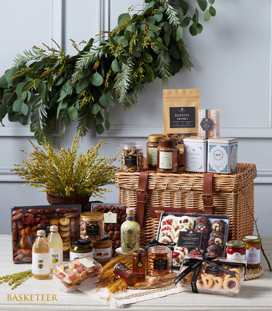Grand luxury gourmet hamper with dried fruits, nuts, preserves, and artisan biscuits in wicker basket