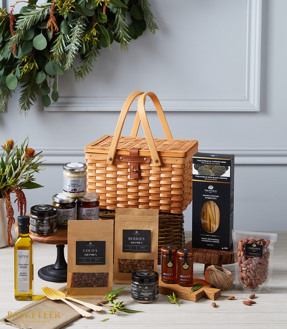 Luxury imported delicacies hamper with woven basket, truffle oils, gourmet spreads, and artisan pasta