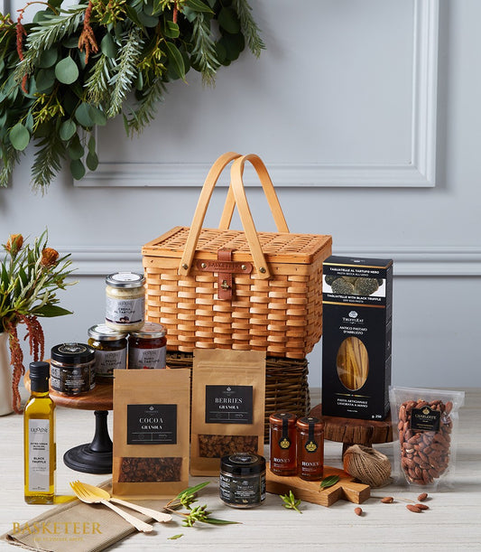 Luxury imported delicacies hamper with woven basket, truffle oils, gourmet spreads, and artisan pasta