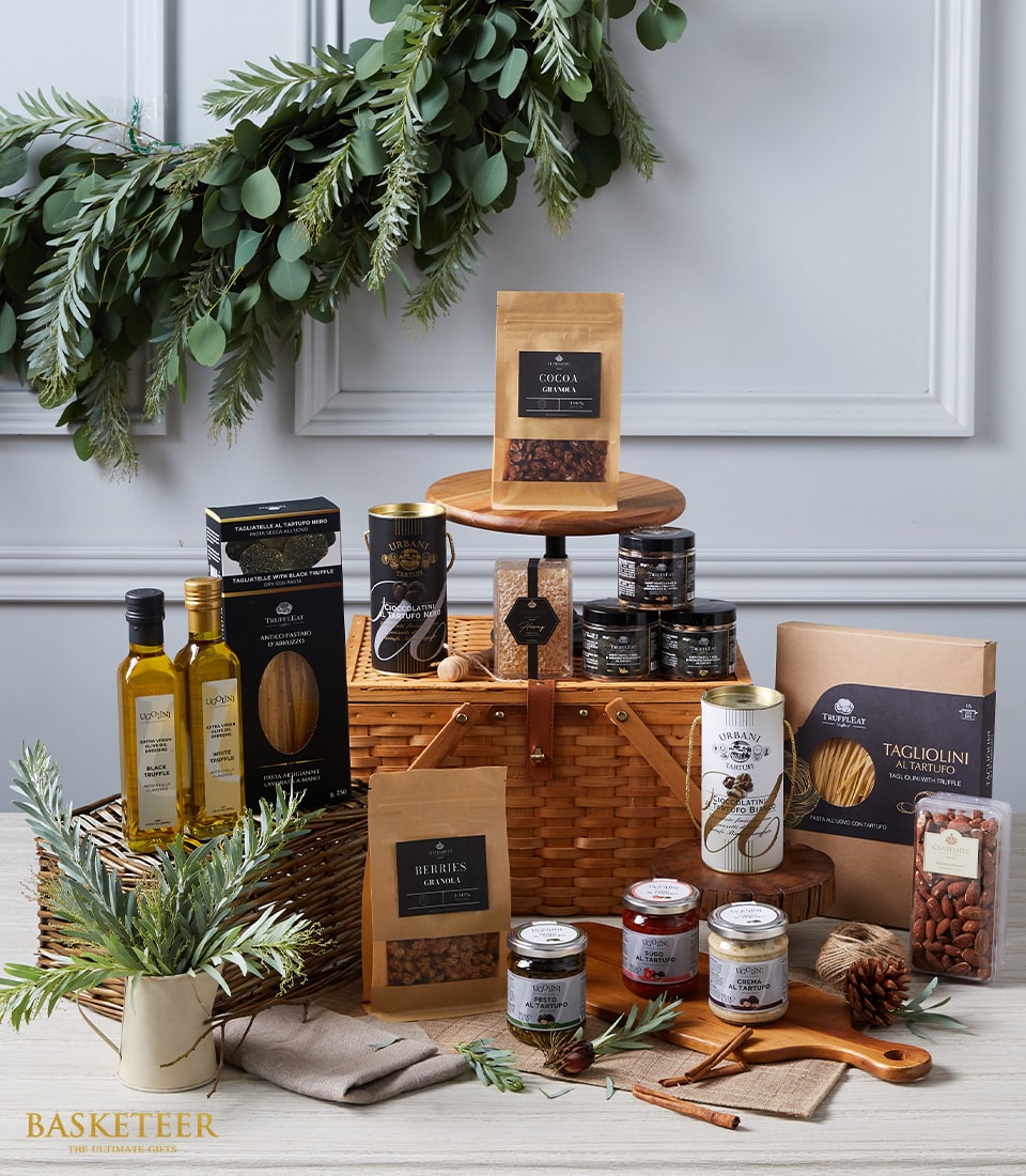 Luxury wicker picnic basket filled with gourmet truffles, olive oils, pasta, and artisan spreads