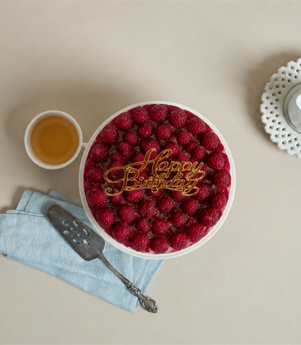 Charlotte Bakery's artisan round birthday cake, generously topped with luscious fresh