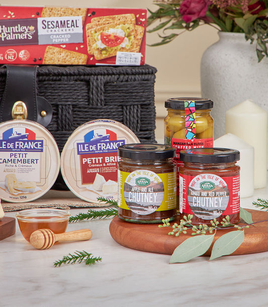 Premium black woven cheese and chutney gift basket with Camembert, Brie, crackers, and artisan chutneys