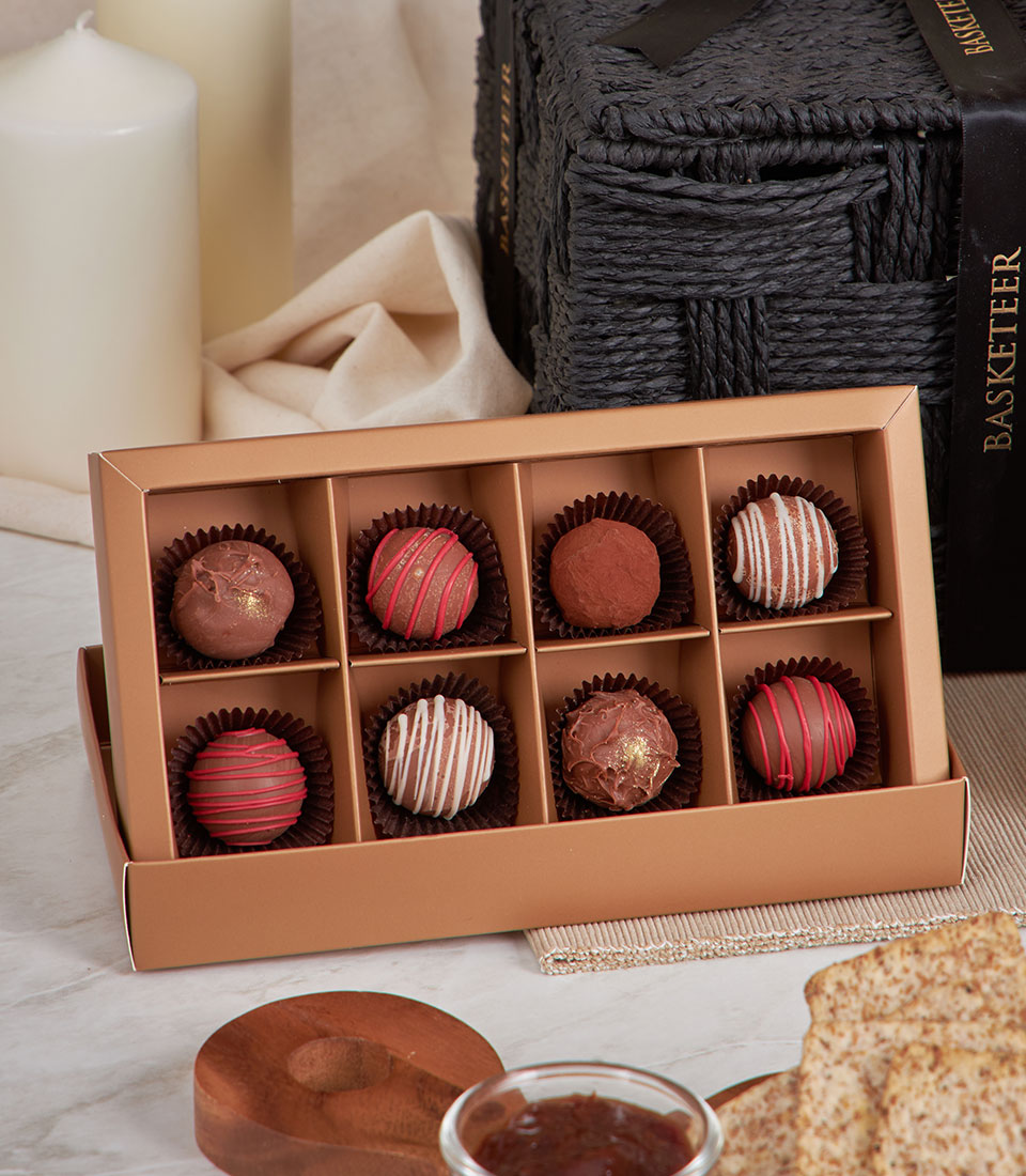 Gourmet cheese and chutney gift basket with artisan chocolate truffles, crackers, and preserves
