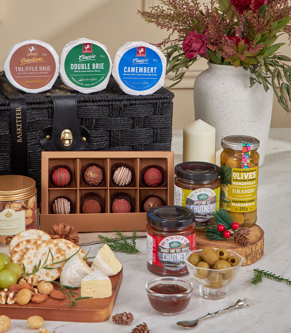 Luxury gourmet gift basket with truffle brie, chocolates, artisan cheddar, chutneys, olives, and crackers