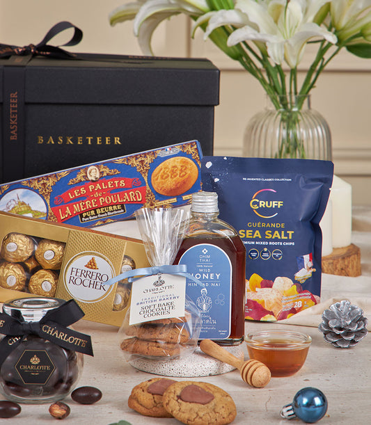Classic Blue luxury gift hamper with gourmet chocolates, artisan cookies, honey, and white lilies for New Year gifting