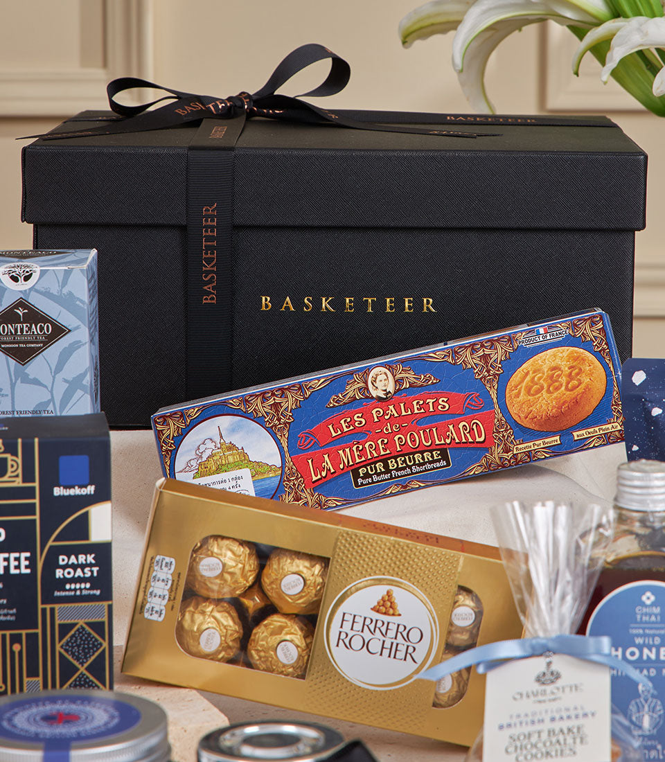 Luxury blue gourmet gift hamper with chocolates, shortbread, tea, and coffee for New Year celebrations