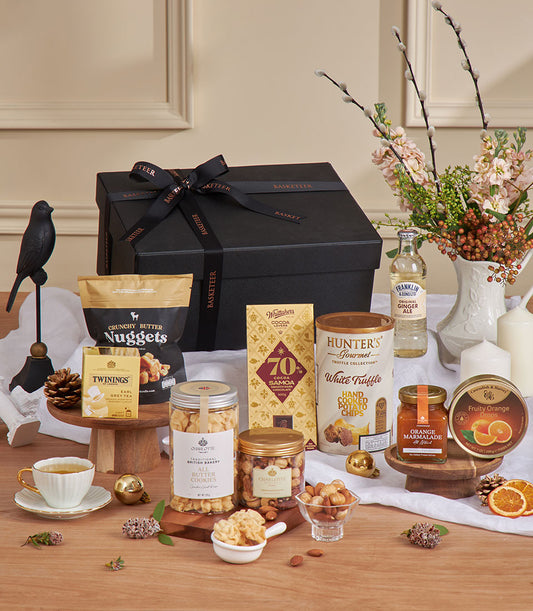 Luxury gift basket with Twinings Earl Grey tea, gourmet chocolates, cookies, and artisan treats in black presentation box