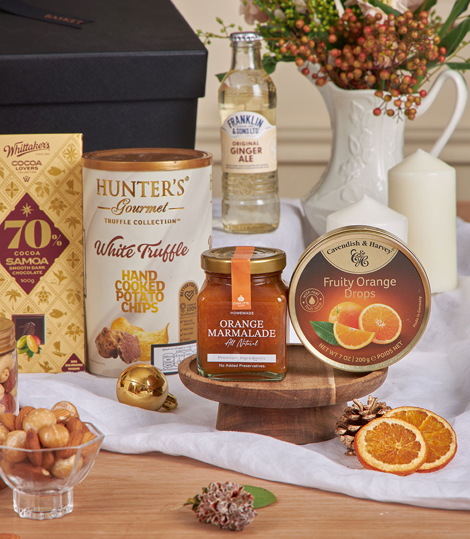 Luxury midnight Earl Grey gift basket with gourmet treats, dark chocolate, and festive décor for New Year