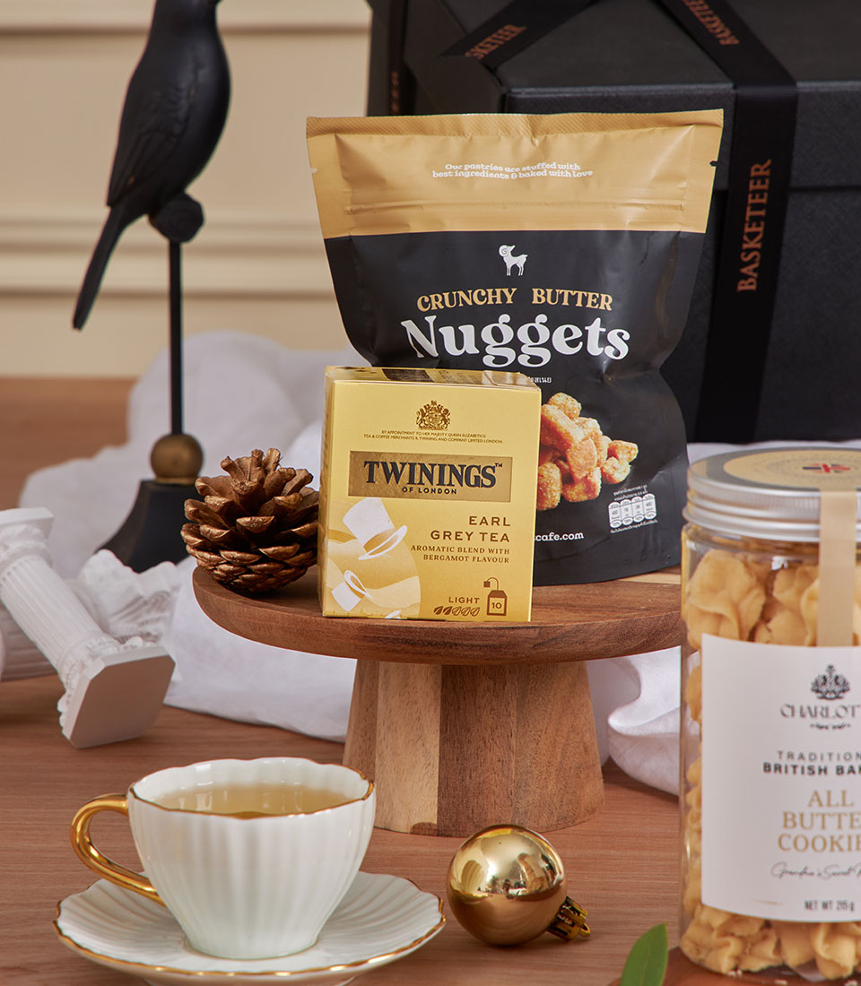Midnight Earl Grey Treats luxury gift basket with Twinings tea, butter cookies, and festive New Year gifts on wooden display