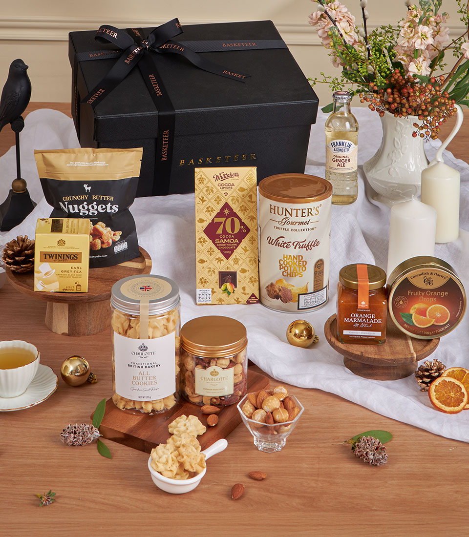 Luxury Midnight Earl Grey gift hamper with gourmet treats, chocolate, tea, and festive black packaging