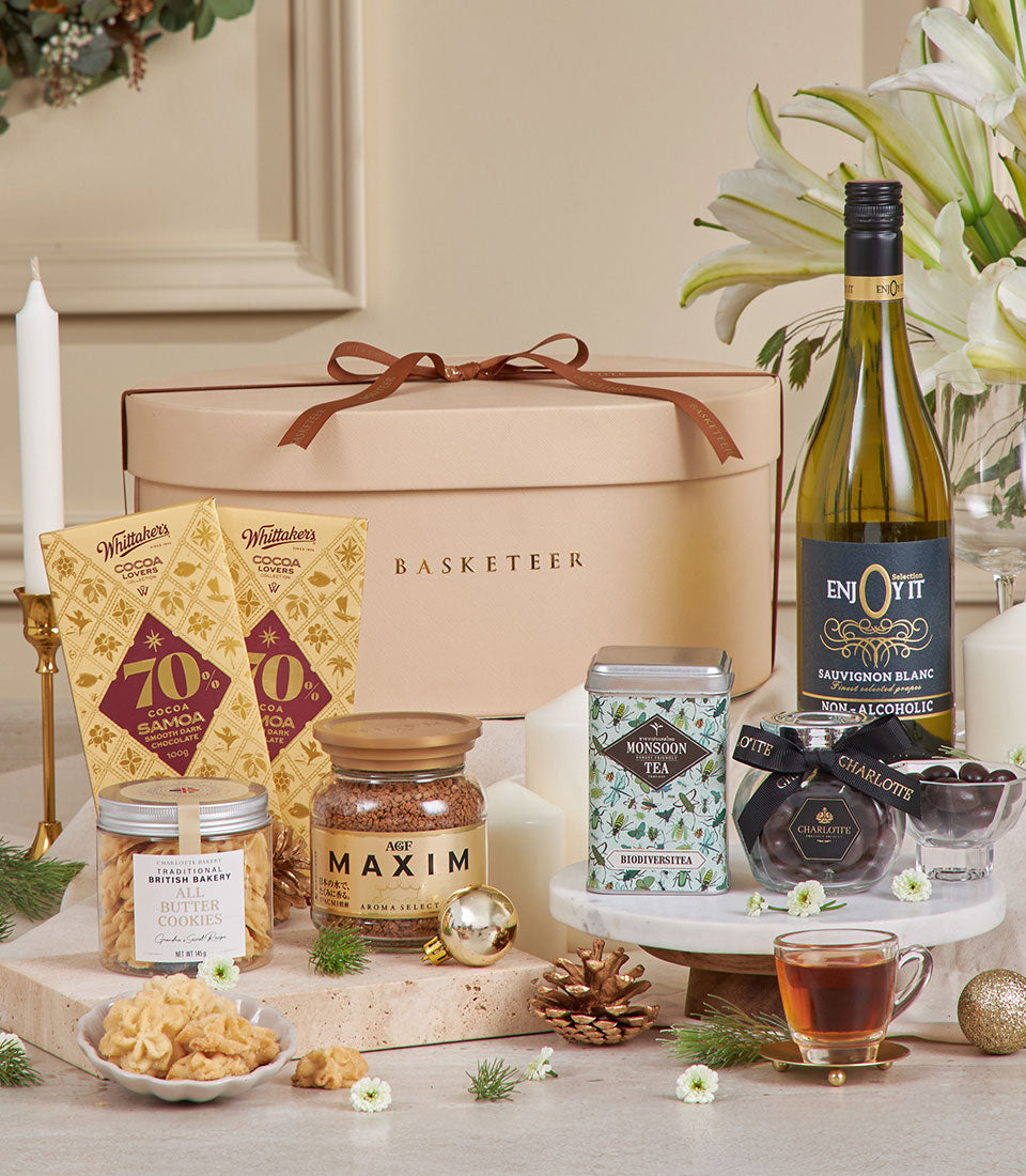 Beige luxury gift hamper with gourmet chocolates, cookies, coffee, tea, and non-alcoholic wine for New Year celebrations