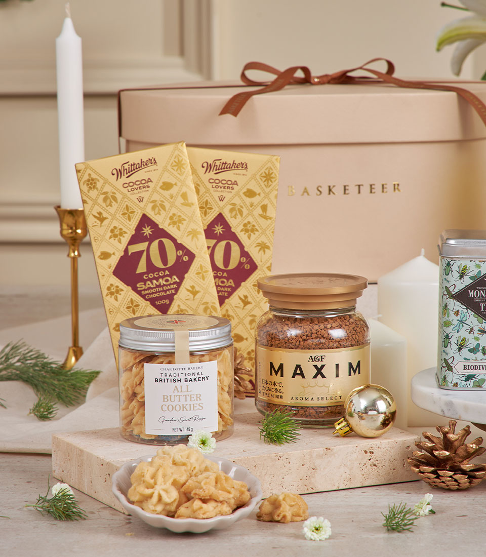 Beige luxury gift basket with gourmet chocolates, butter cookies, instant coffee, and festive candles for New Year