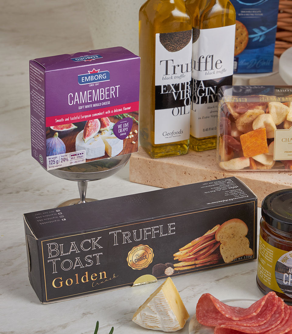 Premium gourmet hamper with black truffle toast, camembert cheese, salami, truffle oil, and dried fruits