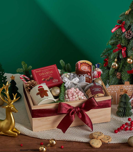 Premium Christmas chocolate and cookies gift box with tiramisu, hot chocolate, and gingerbread treats in red ribbon-tied