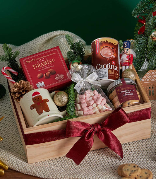 Festive Christmas gift box with tiramisu chocolate, hot chocolate mix, cookies, marshmallows, and gingerbread mug