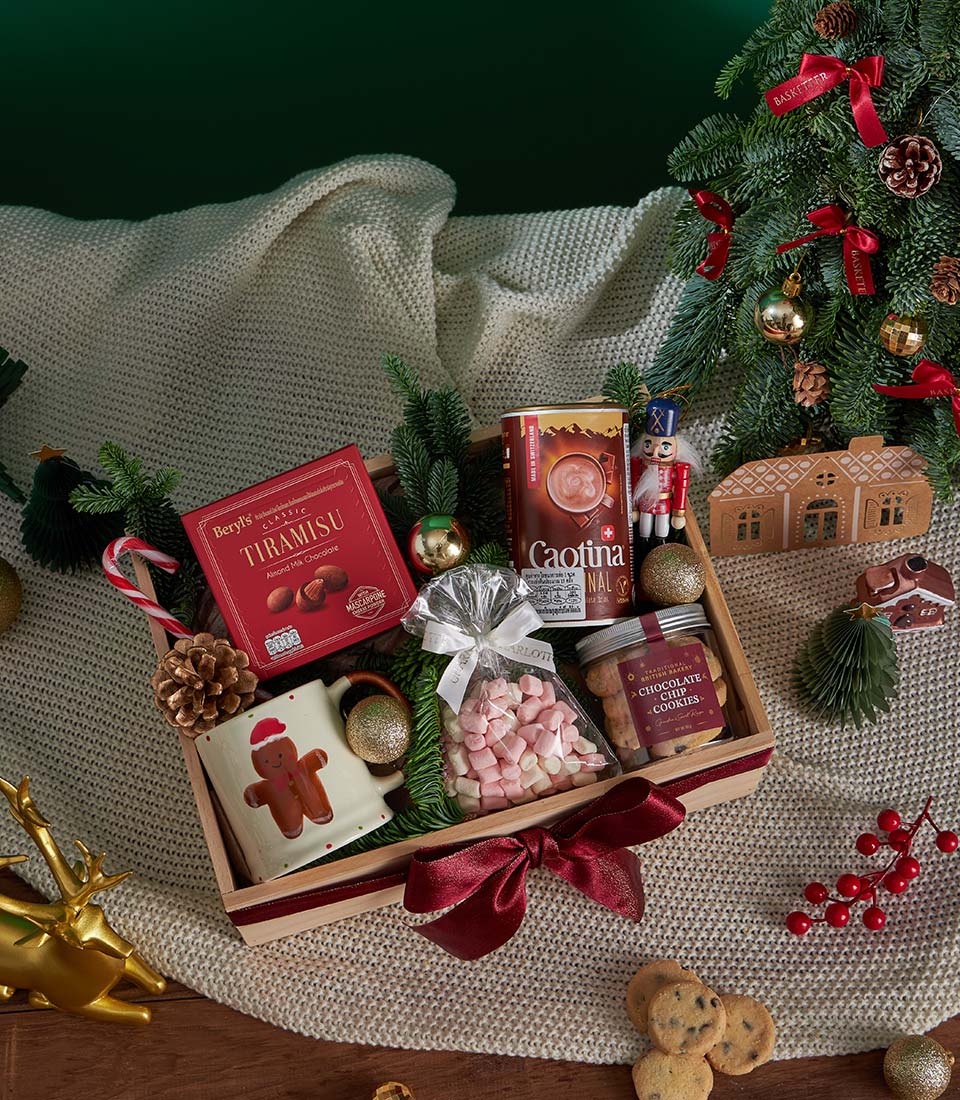Christmas chocolate and cookies gift hamper with hot chocolate, marshmallows, gingerbread mug and festive decorations