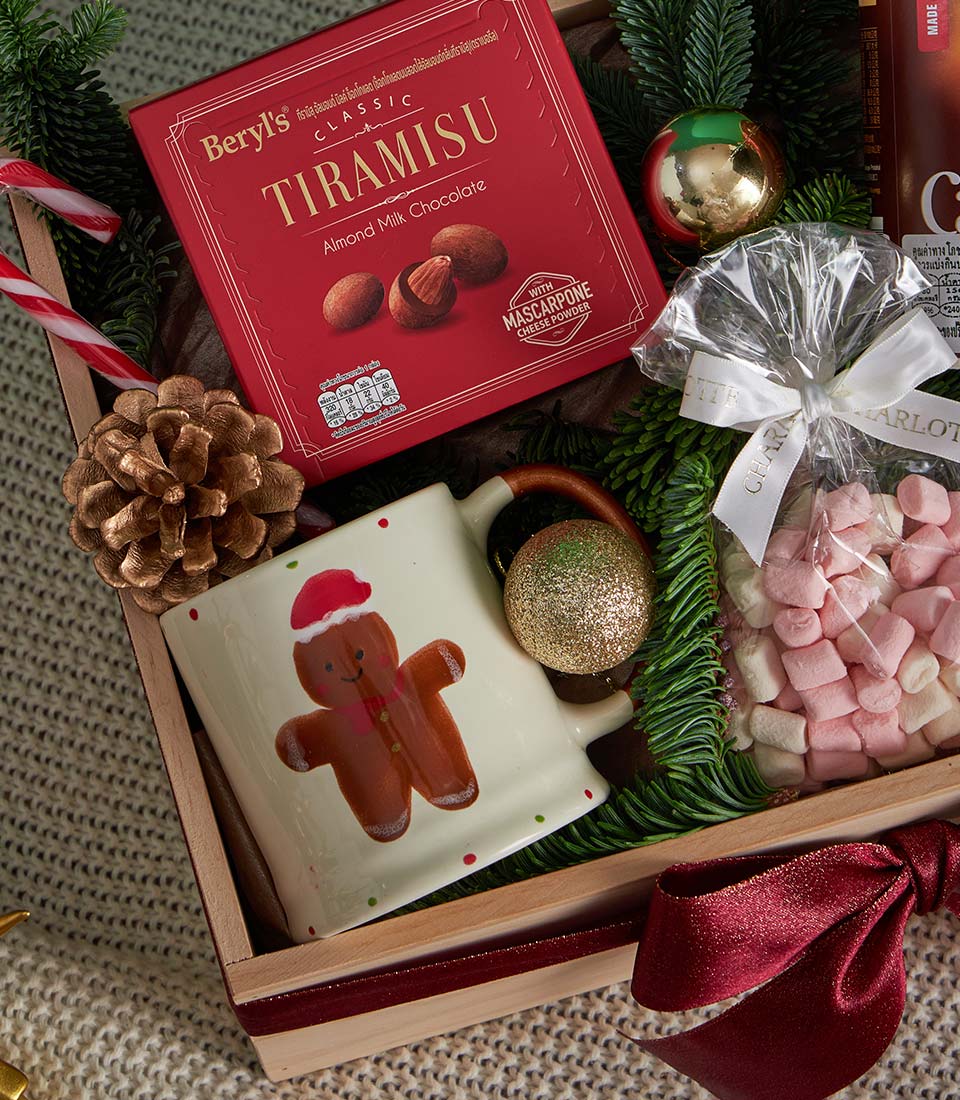 Festive Christmas gift box with tiramisu almond chocolate, gingerbread ceramic mug, marshmallows, and holiday ornaments