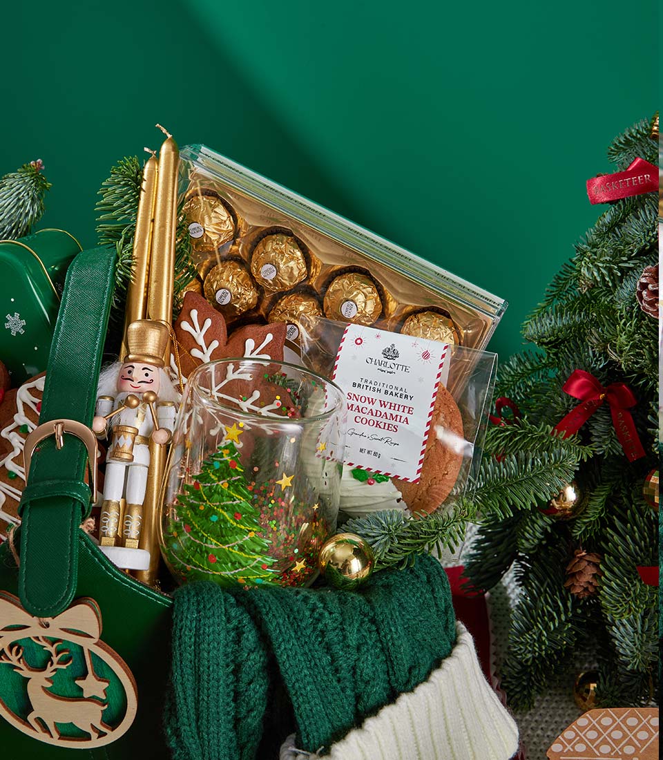 Deluxe Christmas gift set with golden chocolates, macadamia cookies, gingerbread, festive mug, candles, and holiday